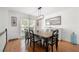 Elegant dining room featuring hardwood floors, wainscoting, and a modern chandelier at 2775 Harper Ferry Dr, Lawrenceville, GA 30044