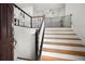 Welcoming entryway with hardwood stairs, white railings, and freshly painted walls at 2775 Harper Ferry Dr, Lawrenceville, GA 30044