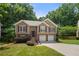 Charming split-level home with brick accents, attached two-car garage, and a well-manicured lawn at 2775 Harper Ferry Dr, Lawrenceville, GA 30044
