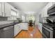 Modern kitchen with stainless steel appliances, granite countertops, and a cozy breakfast nook with natural light at 2775 Harper Ferry Dr, Lawrenceville, GA 30044