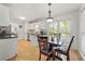 Bright eat-in kitchen with white cabinets, granite countertops, and a window overlooking the backyard at 2775 Harper Ferry Dr, Lawrenceville, GA 30044