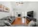 Cozy living room with hardwood floors, a fireplace, and comfortable gray sofas under a vaulted ceiling at 2775 Harper Ferry Dr, Lawrenceville, GA 30044