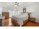 Serene main bedroom with a tray ceiling, hardwood floors, and large windows, offering ample natural light at 2775 Harper Ferry Dr, Lawrenceville, GA 30044