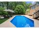 Backyard pool area features lounge chairs and umbrellas for relaxing by the refreshing inground pool at 2775 Harper Ferry Dr, Lawrenceville, GA 30044