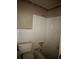 Small bathroom with white tile, toilet, and tub/shower combination at 4595 Sahara Sw Dr, Atlanta, GA 30331