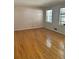 Empty bedroom displaying hardwood floors and two windows offering natural light at 4595 Sahara Sw Dr, Atlanta, GA 30331