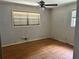 Modest bedroom with wood floors, light gray walls, and two windows at 4595 Sahara Sw Dr, Atlanta, GA 30331