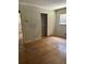 Bedroom featuring wood floors, neutral walls, closet, and a window at 4595 Sahara Sw Dr, Atlanta, GA 30331