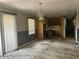 Living room/dining room that opens up to a kitchen featuring damage to the floor and walls at 4595 Sahara Sw Dr, Atlanta, GA 30331
