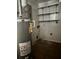 Utility Room features a Rheem water heater, shelving, and peeling paint at 4595 Sahara Sw Dr, Atlanta, GA 30331