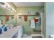 Bright bathroom with updated fixtures, decorative shelving, and shower with curtain at 80 Jacob Trl, Rockmart, GA 30153
