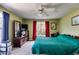Bedroom features natural light, ceiling fan, and dresser with TV, creating a comfortable, inviting space at 80 Jacob Trl, Rockmart, GA 30153