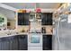 Functional kitchen with black cabinets and stainless steel appliances at 80 Jacob Trl, Rockmart, GA 30153