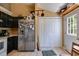 Kitchen area with black cabinets, stainless steel appliances, and tile floor at 80 Jacob Trl, Rockmart, GA 30153