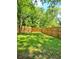 The expansive green yard is privately enclosed with a beautiful wood fence at 1081 Hardin Street Sw St, Conyers, GA 30012