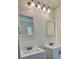 Dual sink vanity in the bathroom with bright lighting and mirrors at 1081 Hardin Street Sw St, Conyers, GA 30012