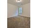 Carpeted bedroom with neutral walls and a window with blinds at 1081 Hardin Street Sw St, Conyers, GA 30012