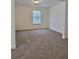 Bright bedroom with neutral carpeting and a window providing natural light at 1081 Hardin Street Sw St, Conyers, GA 30012