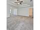 Spacious bedroom with tray ceilings, neutral carpet, and an open layout at 1081 Hardin Street Sw St, Conyers, GA 30012