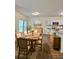 Cozy dining room with a farmhouse-style table, rustic decor, and an eat-in kitchen in the background at 1081 Hardin Street Sw St, Conyers, GA 30012