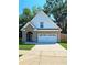 Charming brick two-story home with a white garage door and arched entryway at 1081 Hardin Street Sw St, Conyers, GA 30012