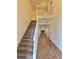The foyer shows the staircase and hardwood floors with a glimpse into the living area at 1081 Hardin Street Sw St, Conyers, GA 30012