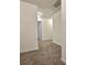 Hallway with neutral carpeting leading to various rooms in the house at 1081 Hardin Street Sw St, Conyers, GA 30012