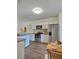 Kitchen with stainless steel appliances, white cabinets, and granite countertops, table, and decorative plants at 1081 Hardin Street Sw St, Conyers, GA 30012
