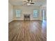 A spacious living room features hardwood floors and a stone fireplace at 1081 Hardin Street Sw St, Conyers, GA 30012