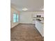 Bright living room with wood floors, white walls, and an eat-in kitchen with stainless steel appliances at 1081 Hardin Street Sw St, Conyers, GA 30012