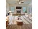 The staged living room is decorated with modern furniture and a cozy rug at 1081 Hardin Street Sw St, Conyers, GA 30012
