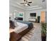 Elegant main bedroom with tray ceilings, ceiling fan, and a glimpse of a sitting area at 1081 Hardin Street Sw St, Conyers, GA 30012