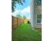 View of the grassy side yard with a wood privacy fence and the side of the home at 1081 Hardin Street Sw St, Conyers, GA 30012
