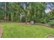 A well-maintained backyard features a large, green lawn, a storage shed, and a privacy fence at 1625 Bill Murdock Rd, Marietta, GA 30062