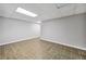 Spacious basement featuring tile flooring, neutral-colored walls, and ample lighting at 1625 Bill Murdock Rd, Marietta, GA 30062