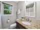 Bathroom featuring granite countertops, an undermount sink, and a window overlooking the outdoors at 1625 Bill Murdock Rd, Marietta, GA 30062