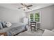 Bedroom features natural light from the window, ceiling fan, and desk with chair at 1625 Bill Murdock Rd, Marietta, GA 30062