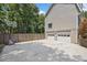 A two-car garage with white doors is shown beside a driveway with a basketball hoop at 1625 Bill Murdock Rd, Marietta, GA 30062