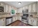 Bright kitchen featuring stainless steel appliances, stone countertops, and decorative backsplash at 1625 Bill Murdock Rd, Marietta, GA 30062