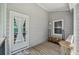 Covered front porch with wood flooring and gray siding features a wooden railing and welcome mat at 1625 Bill Murdock Rd, Marietta, GA 30062
