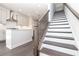 Modern kitchen with stainless steel appliances and a central island, adjacent to a staircase at 352 Olmstead Way # 28, Alpharetta, GA 30022