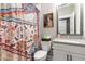 Stylish bathroom featuring a colorful shower curtain, framed art, and a modern vanity at 506 Broadview Ne Pl, Atlanta, GA 30324