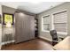 Bedroom featuring a built-in Murphy bed, a modern desk, and ample natural light at 506 Broadview Ne Pl, Atlanta, GA 30324