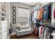 Walk-in closet with custom shelving, ample storage space, and a cozy seating area at 506 Broadview Ne Pl, Atlanta, GA 30324