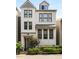 Charming two-story home with white brick exterior, black-framed windows, and professional landscaping at 506 Broadview Ne Pl, Atlanta, GA 30324