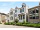 Charming, modern, three-story white brick home with black-trimmed windows, black metal fence, and verdant landscaping at 506 Broadview Ne Pl, Atlanta, GA 30324