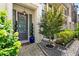 View of the front door with an ornamental tree, a brick walkway, and meticulously maintained shrubbery at 506 Broadview Ne Pl, Atlanta, GA 30324