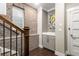 Hallway featuring exposed brick and a staircase at 506 Broadview Ne Pl, Atlanta, GA 30324