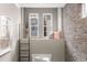 Charming hallway nook with exposed brick, perfect for a reading or relaxation space, filled with natural light at 506 Broadview Ne Pl, Atlanta, GA 30324