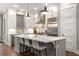 Modern kitchen with an island, white cabinets, stainless steel refrigerator, and hardwood flooring at 506 Broadview Ne Pl, Atlanta, GA 30324